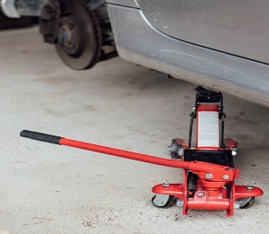Where to place a floor jack under car